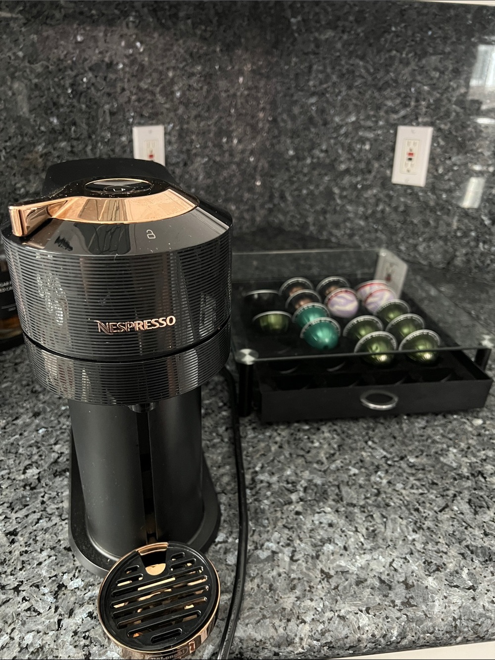 Nespresso Single-Serve Coffee Machine in Black with Rose Gold Accents.